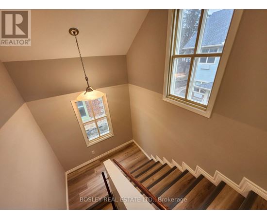 A staircase with a light hanging from the ceiling.