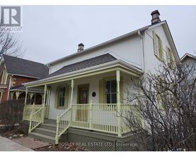 A white house with a green front porch.