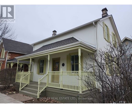 A white house with a green front porch.