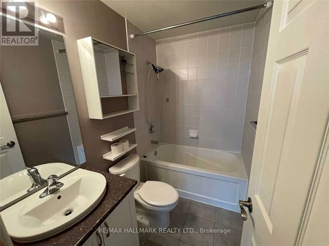 A bathroom with a sink, toilet, and bathtub.