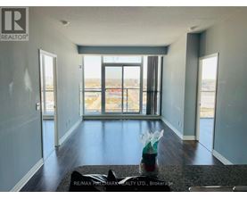 A large, empty room with a view of the city through the windows.