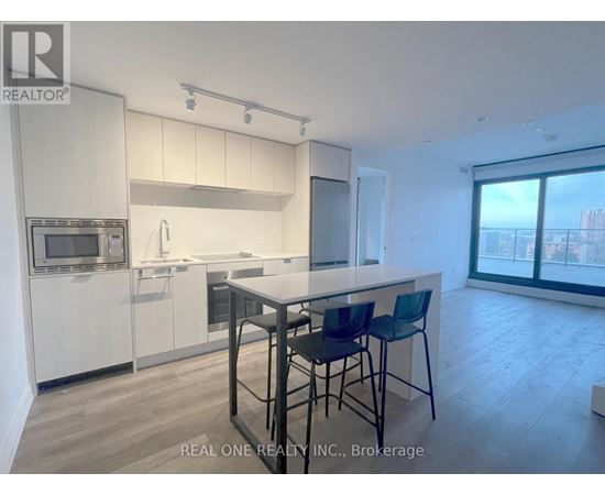 A modern kitchen with white cabinets and a large island.