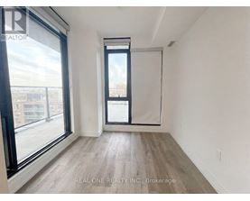 A room with a large window and a sliding door.