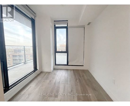 A room with a large window and a sliding door.