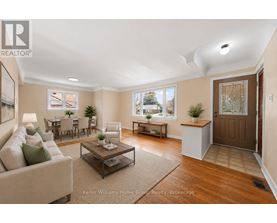 A well-lit living room with a couch, coffee table, and a door.