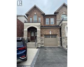 A house with a garage and a car parked in front.