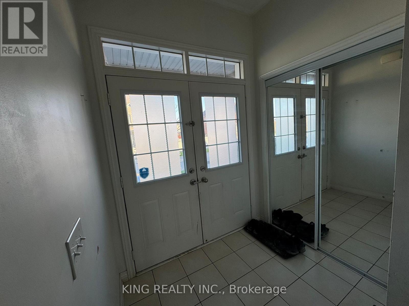A room with a white door and a window with a white frame.