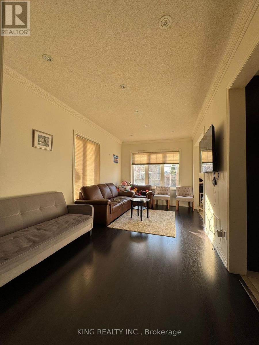 A living room with a grey couch and a brown leather couch.