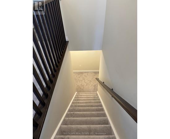 A spacious, unfinished basement with a concrete floor and exposed ceiling beams.