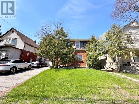 A residential area with houses and parked cars.