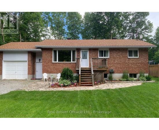 A house with a red brick exterior and a white door is for sale.
