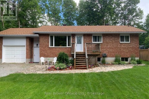 A house with a red brick exterior and a white door is for sale.