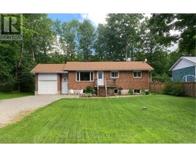 A house with a brown roof and a white garage door is for sale.