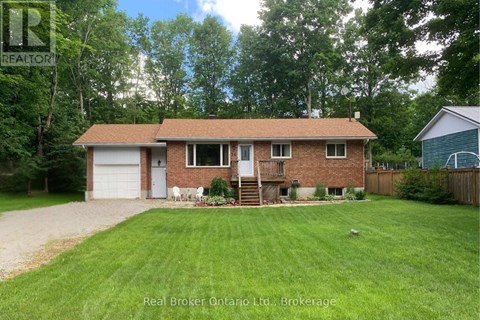 A house with a brown roof and a white garage door is for sale.