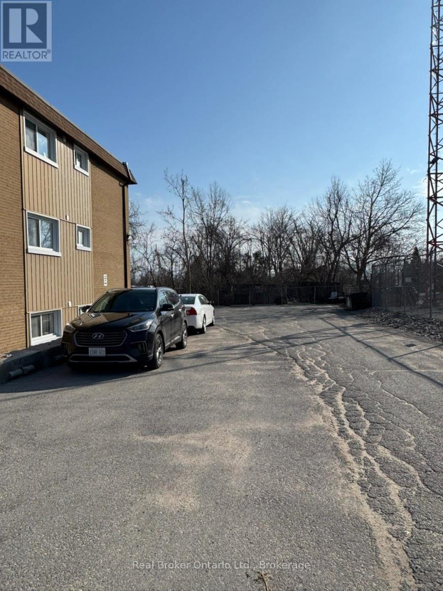 A parking lot with cars and a building in the background.