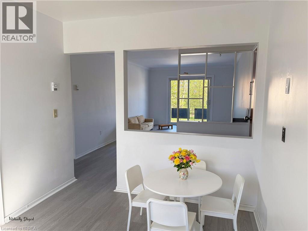 A dining room with a white table and chairs.