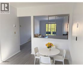 A dining room with a white table and chairs.