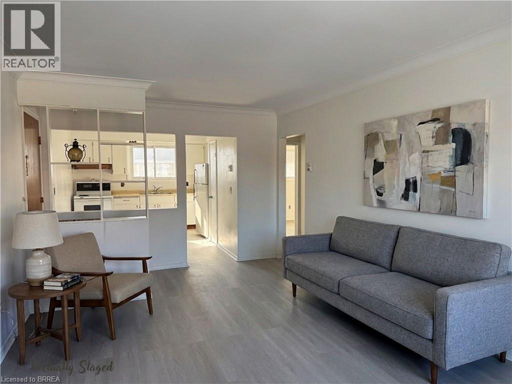 A living room with a grey couch and a wooden table.