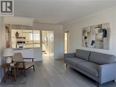 A living room with a grey couch and a wooden table.