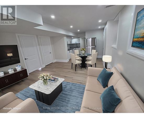 A living room with a beige sofa, a coffee table, and a painting on the wall.