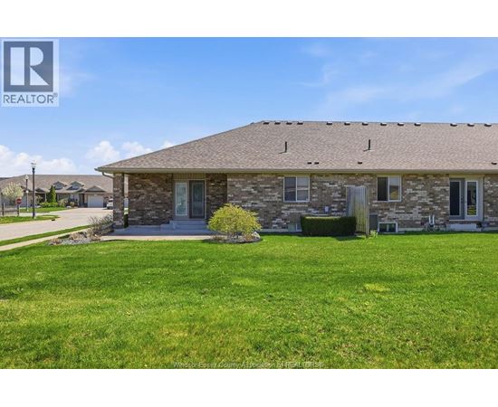 A house with a lawn in front of it.