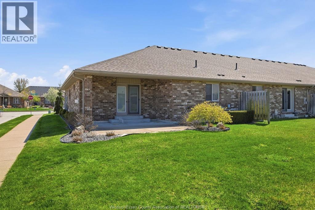 A house with a well-kept lawn in front of it.