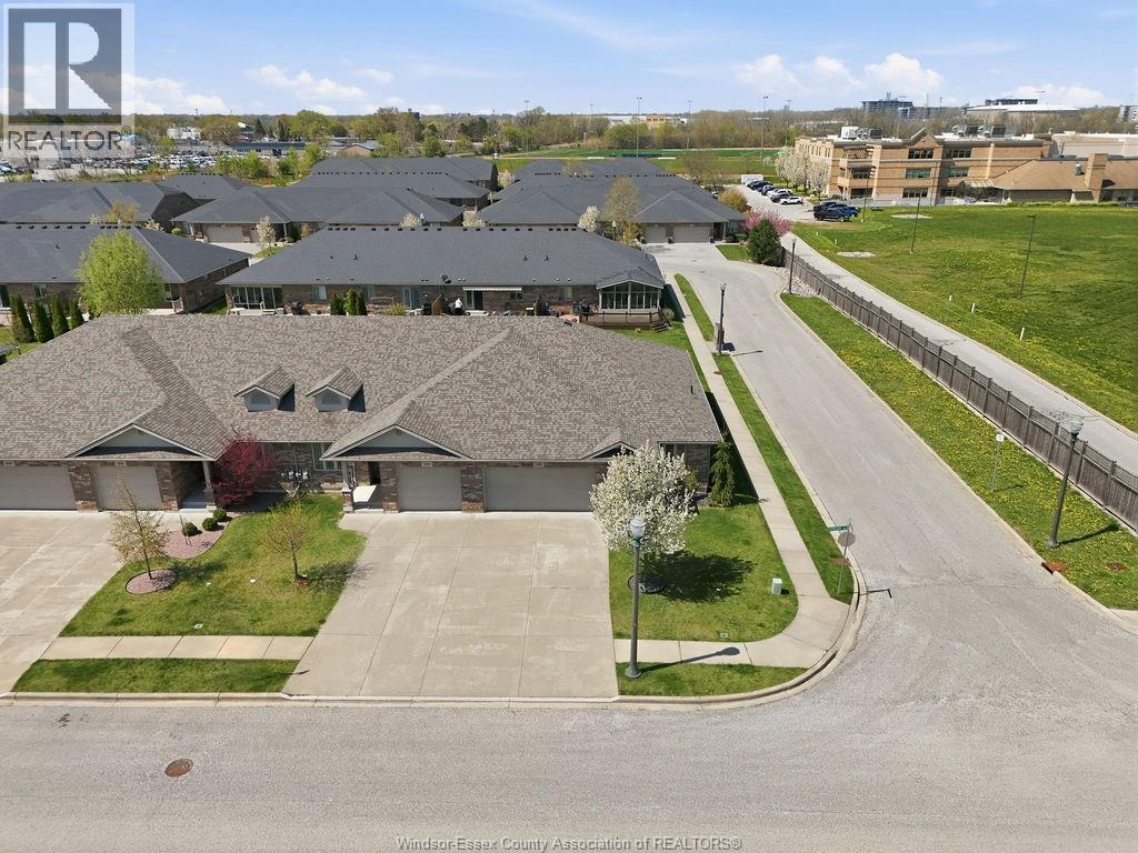 A realtor photo of a residential area with houses and a road.