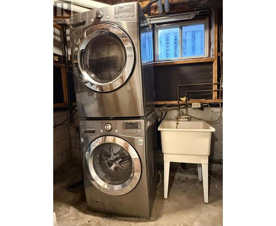 A washing machine and dryer stacked on top of each other in a laundry room.