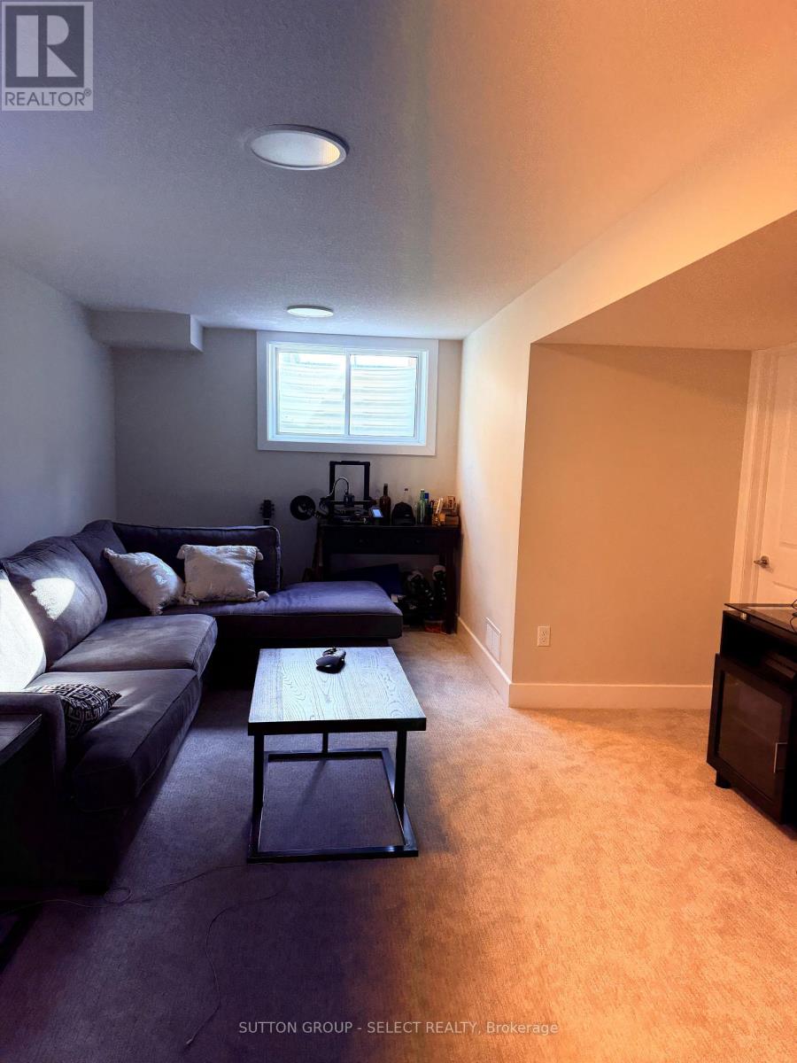 A living room with a couch, coffee table, and fireplace.