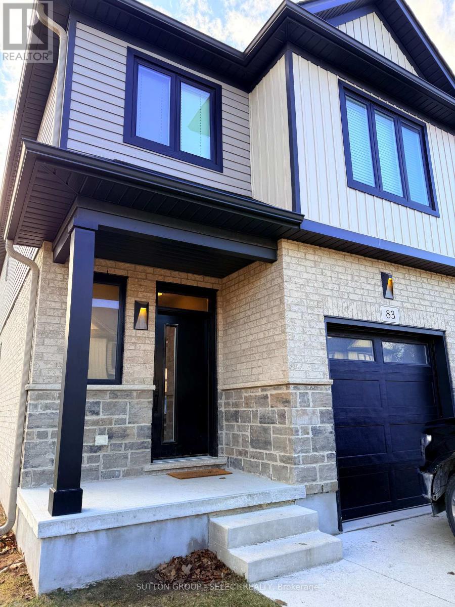 A house with a black front door and a garage door.
