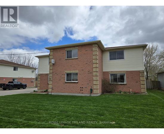 A house with a grassy yard in front of it.