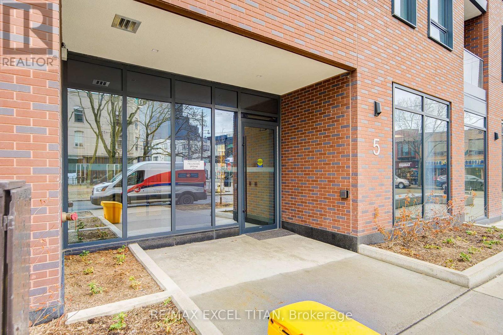 The front of a building with a glass door and a sign that says REALTOR.