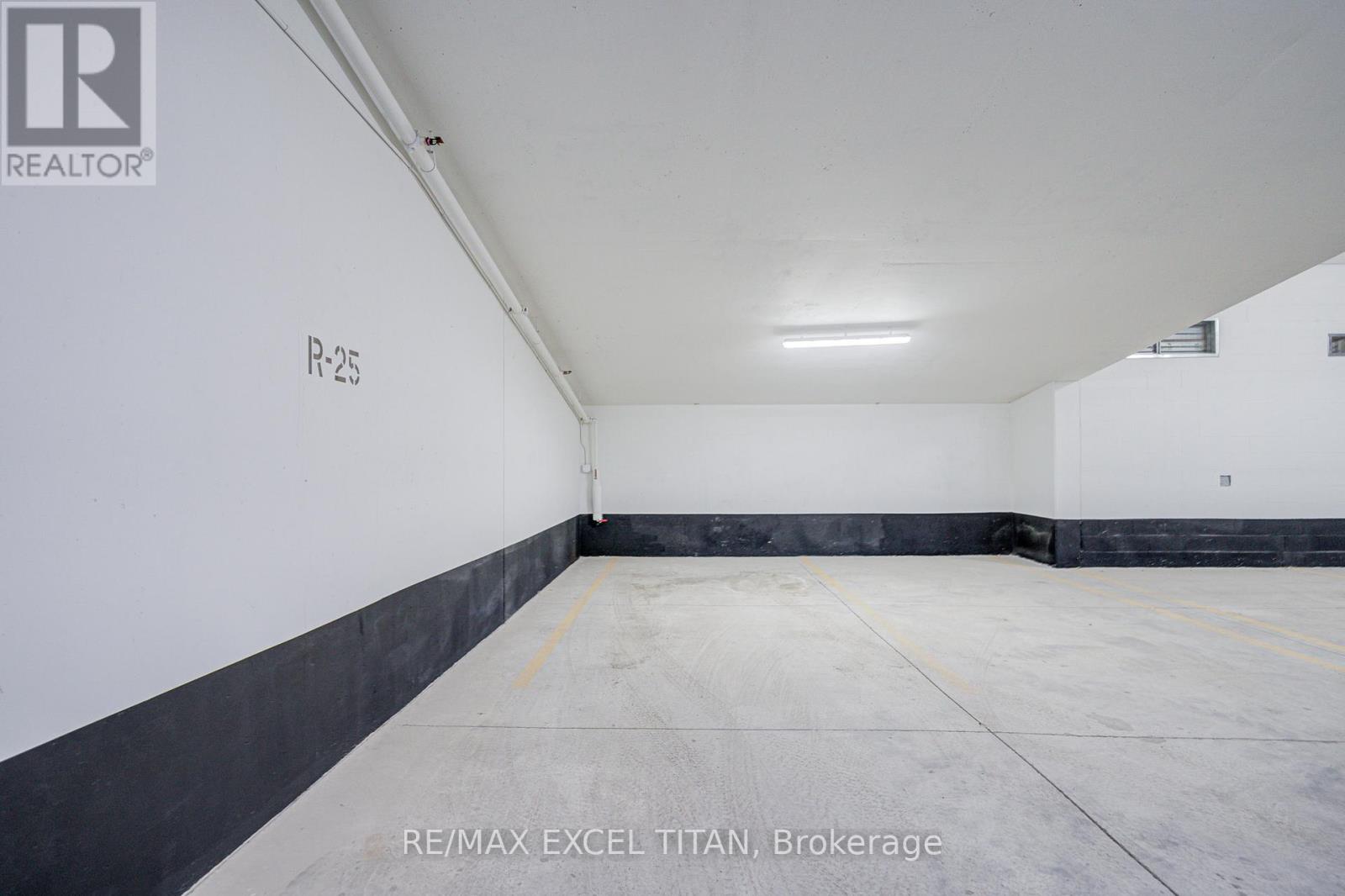 A large, empty warehouse space with a concrete floor and white walls.