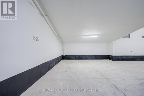 A large, empty warehouse space with a concrete floor and white walls.