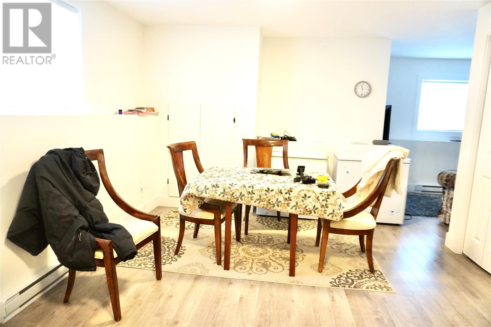 A dining room with a table set for two.