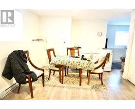 A dining room with a table set for two.