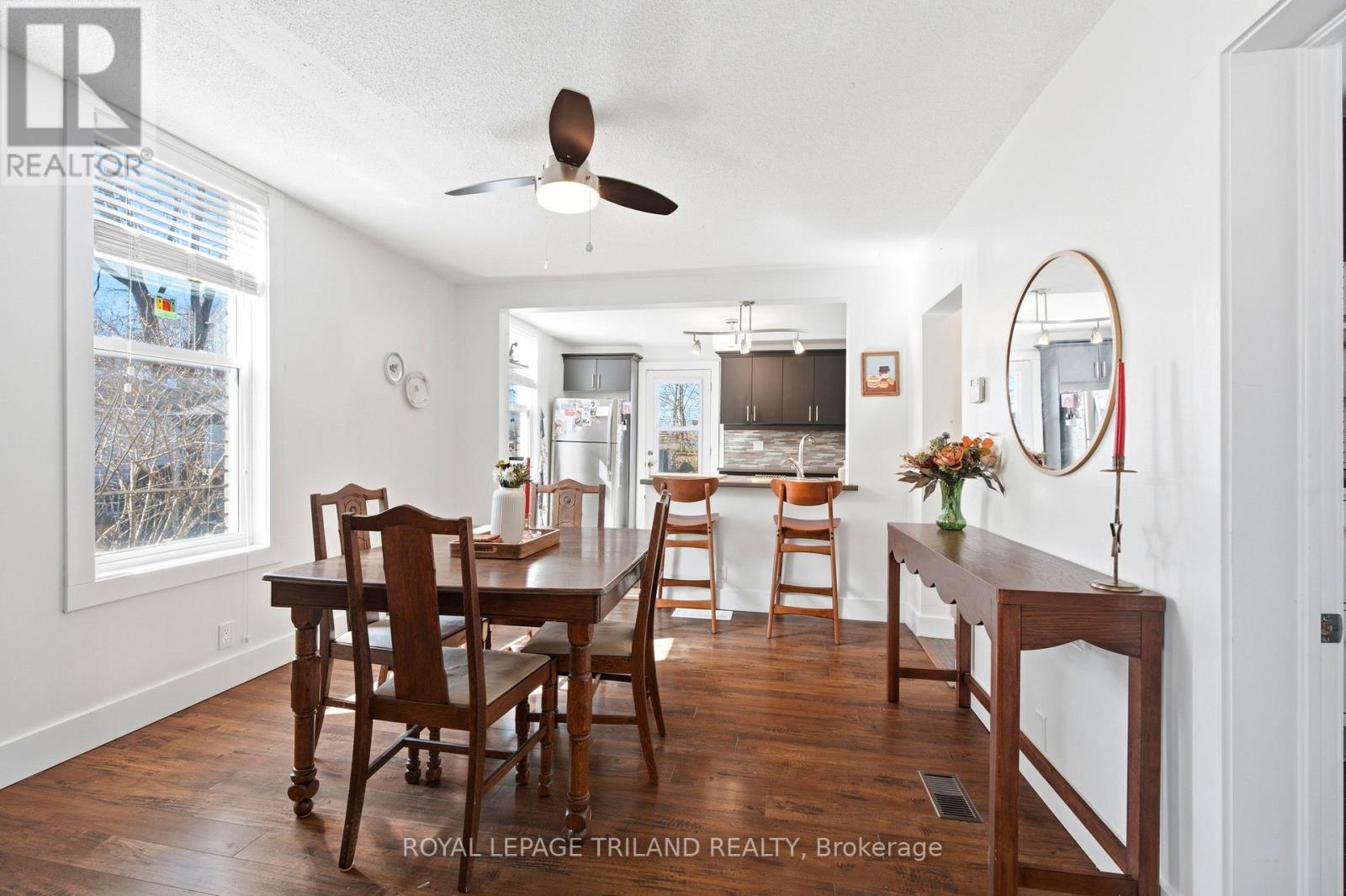 A dining room with a table and chairs.
