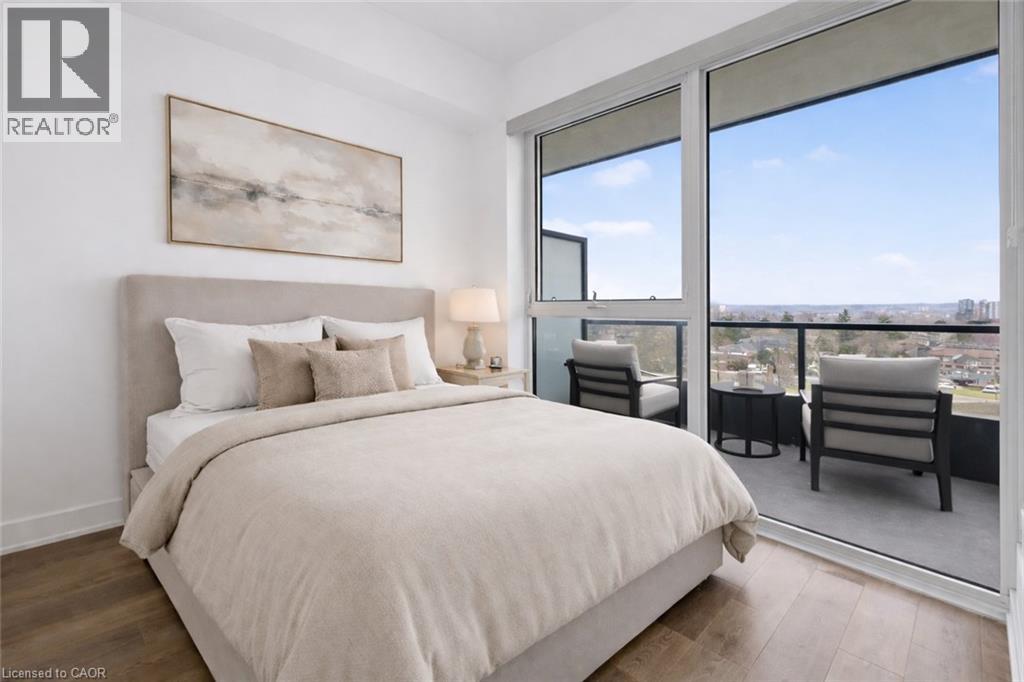 A bedroom with a large bed and a view of the city.
