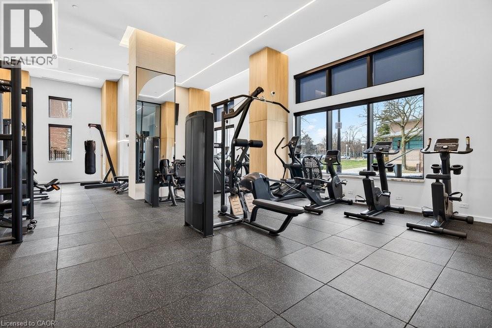 A well-equipped gym with various exercise machines and a large mirror.