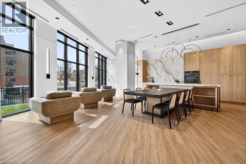 A modern living room with a dining table and chairs.