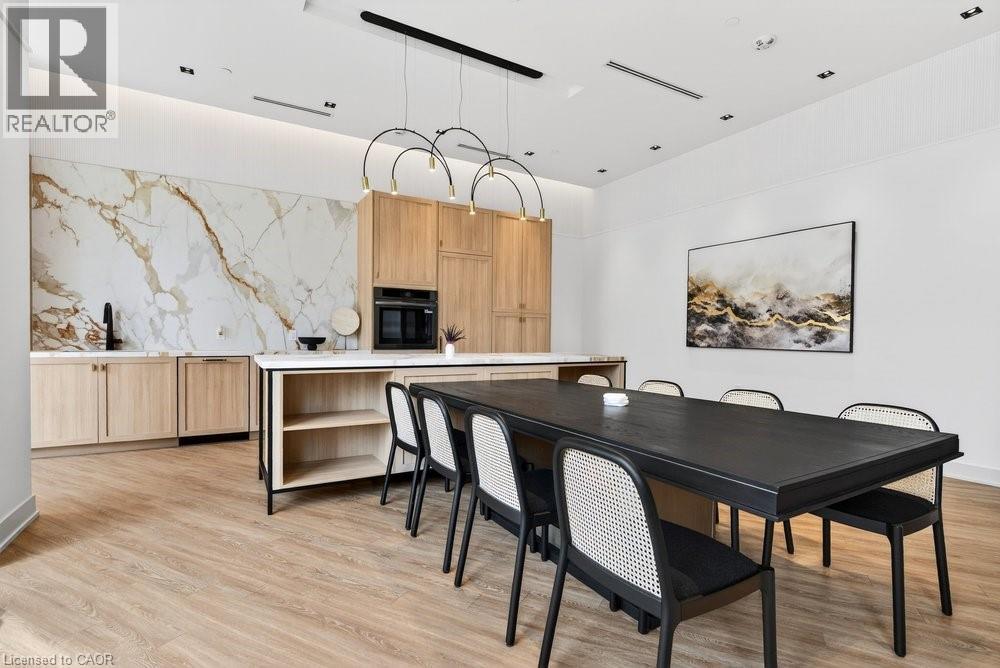 A modern dining room with a black table and chairs.