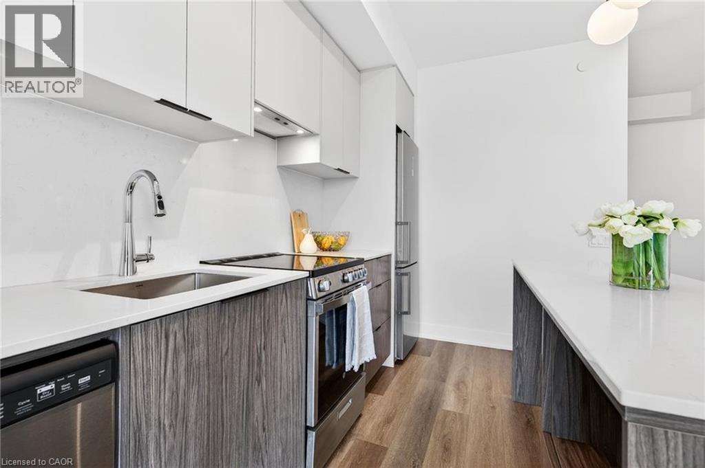 A modern kitchen with a stainless steel dishwasher and wooden cabinets.