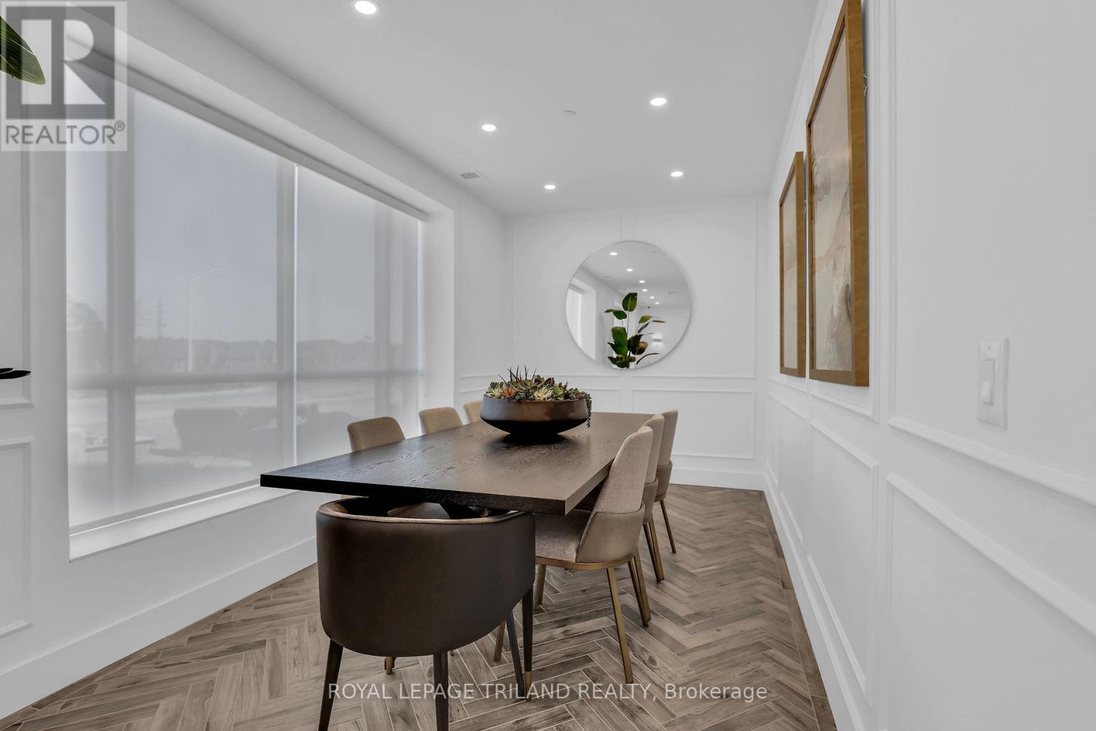 A dining room with a table set for four.