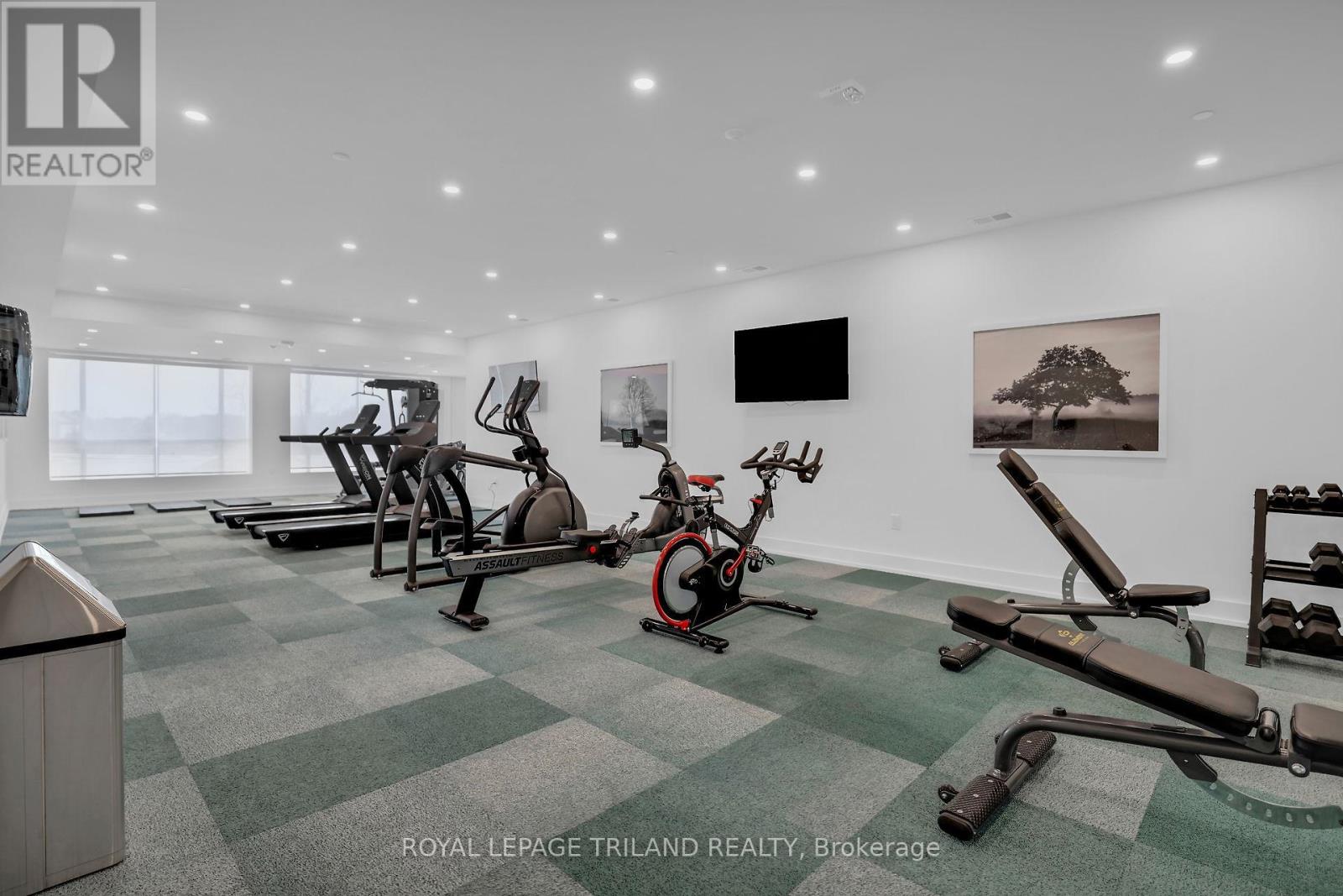 A gym with a green and white checkered floor and exercise equipment.