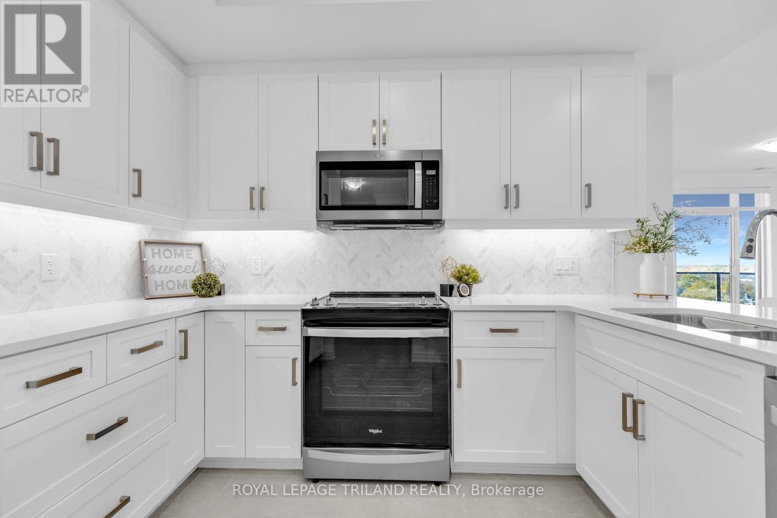 A modern kitchen with white cabinets and a black oven.