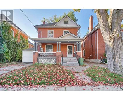 A house with a red brick exterior and a white door.
