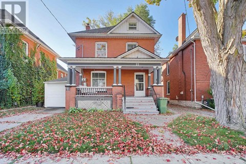 A house with a red brick exterior and a white door.