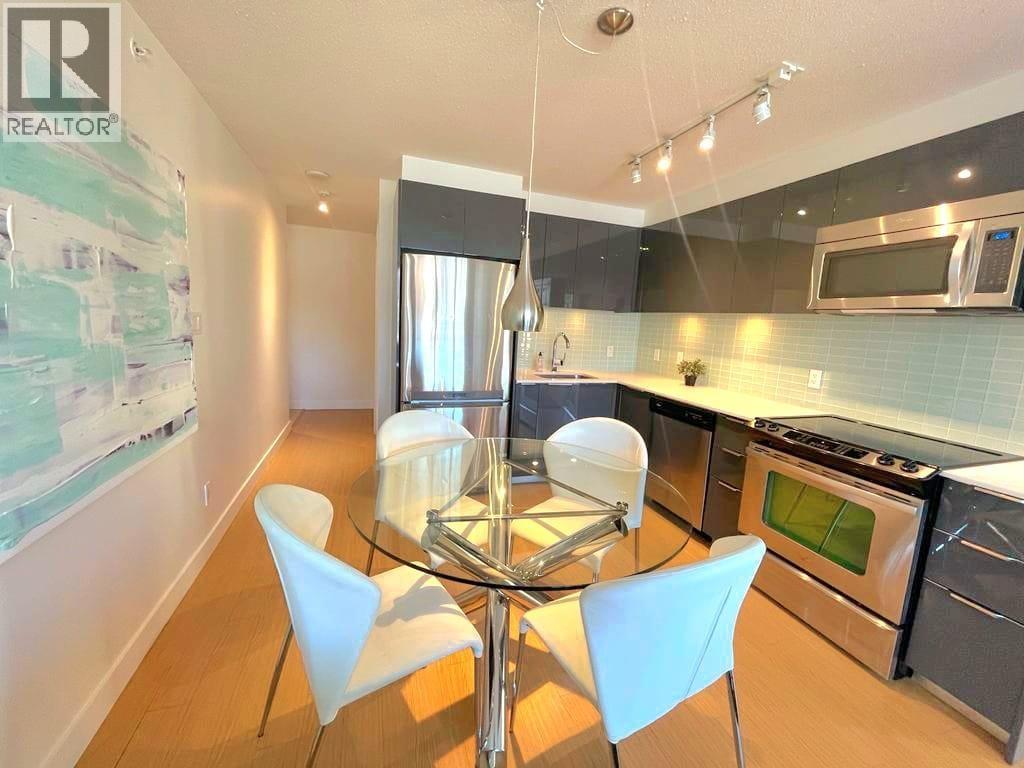 A modern kitchen with a glass table and chairs.