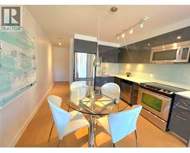 A modern kitchen with a glass table and chairs.