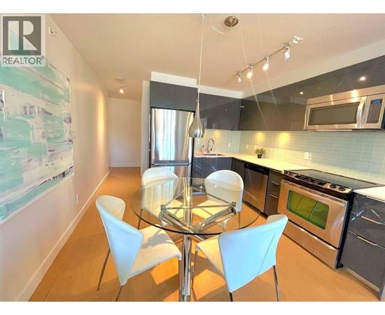 A modern kitchen with a glass table and chairs.